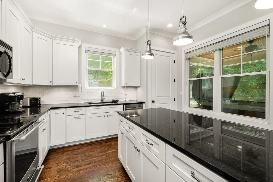 From the kitchen, you'll overlook the hot tub located in the screened porch