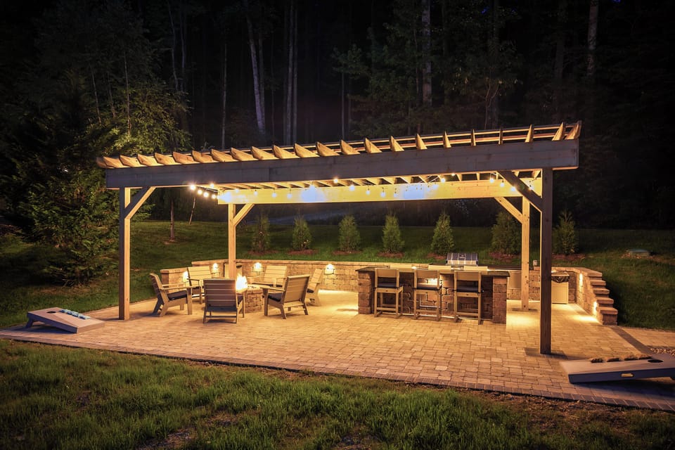 Day or night, enjoy the patio with grill, fire pit, cornhole, and bar seating.