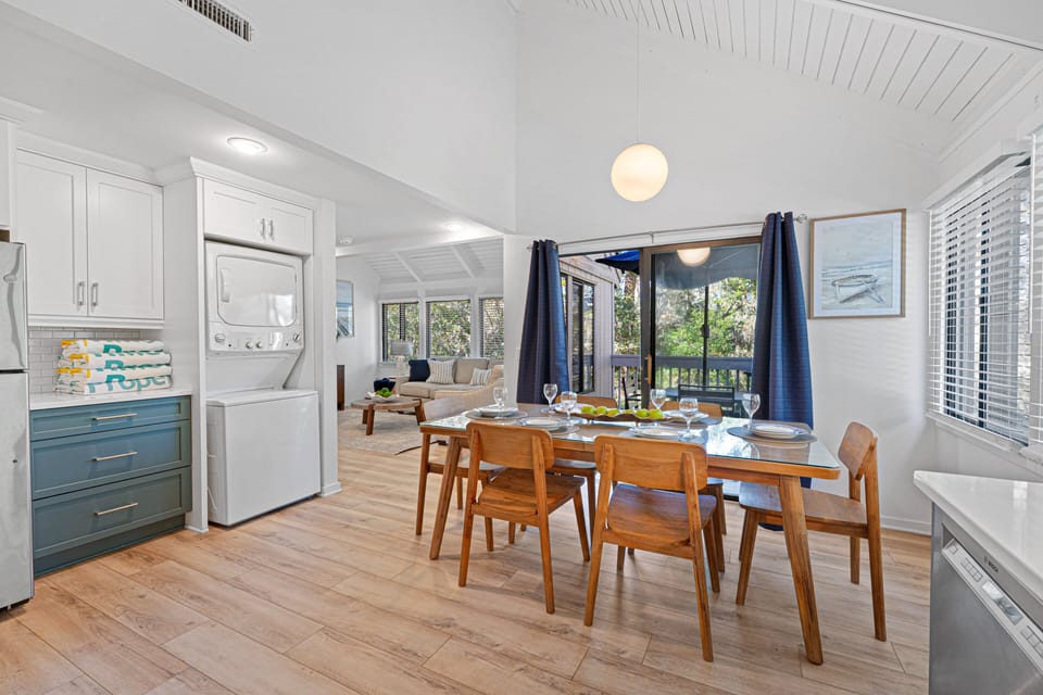The dining space sits beside large picture windows with tranquil views.