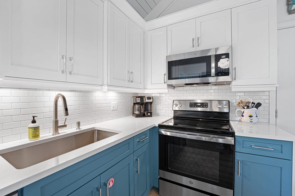 Ample counter space and thoughtful storage make meal preparation convenient, while the bright, modern finishes create a polished, inviting look.