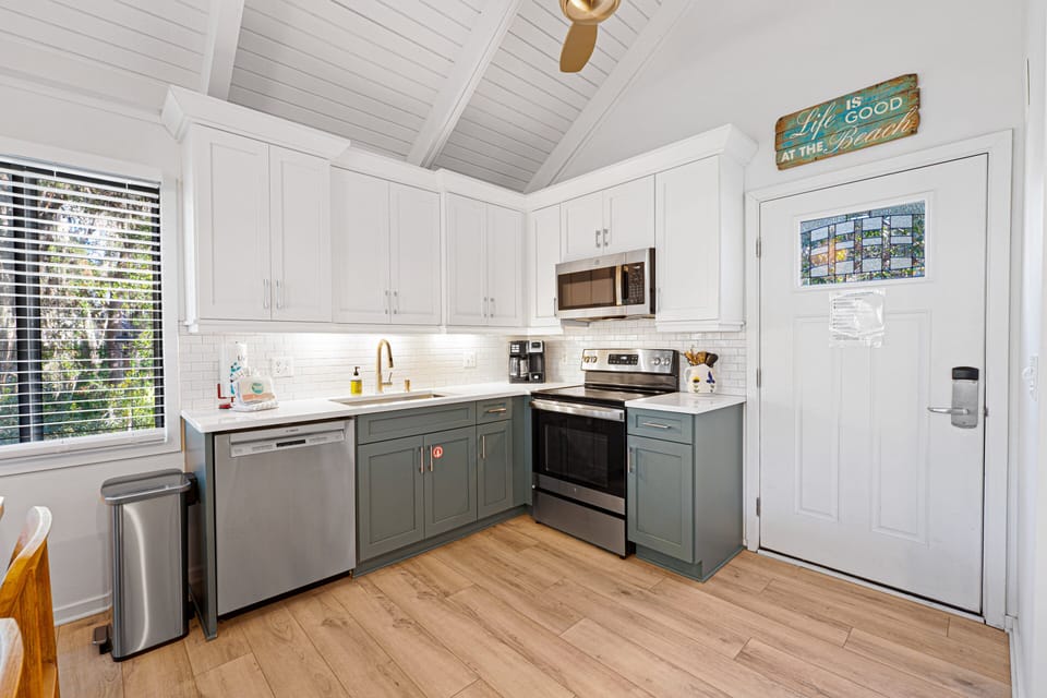 Stainless-steel appliances and a spacious peninsula with pull-up seating make meal prep effortless.