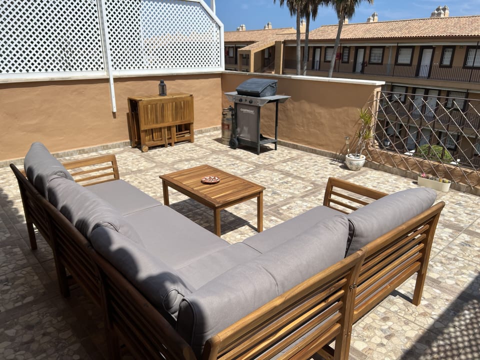 Beautiful terrace with sofa, foldaway table and chairs to eat, bbq and sun shade