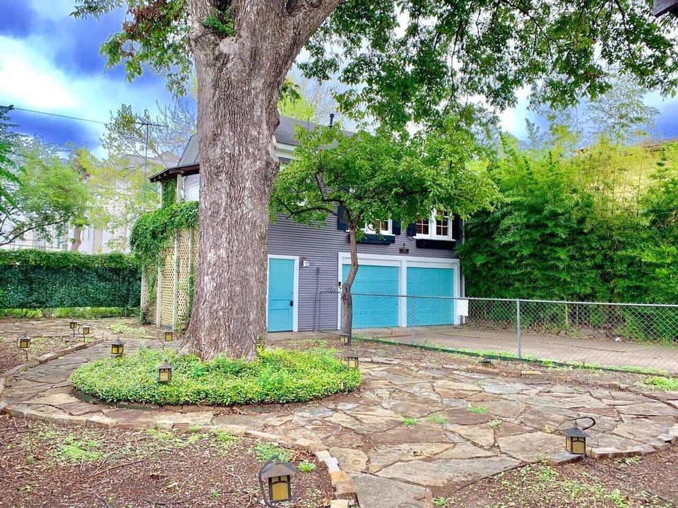 Back porch with a 200 year old pecan tree. The back yard is a shared space with the garage apartment. Please note there is no garage or driveway access. 