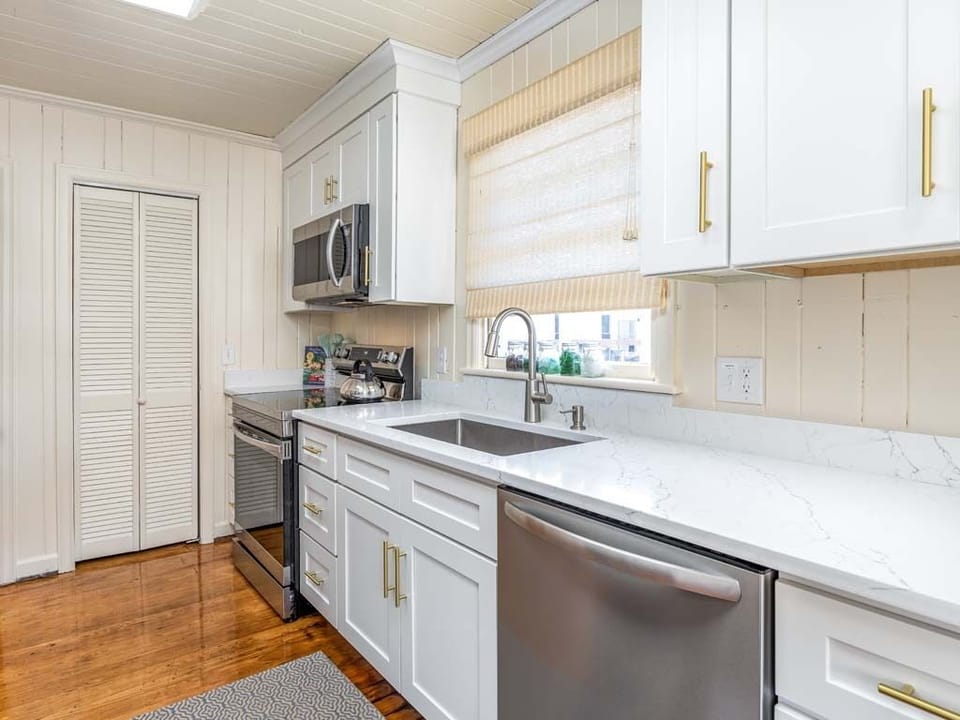 Updated galley kitchen with all stainless steel appliances.