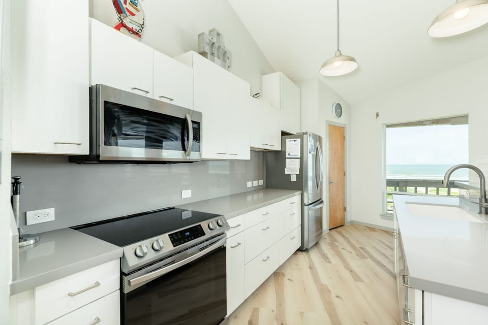 Fully equipped kitchen with abundant storage and stainless steel appliances