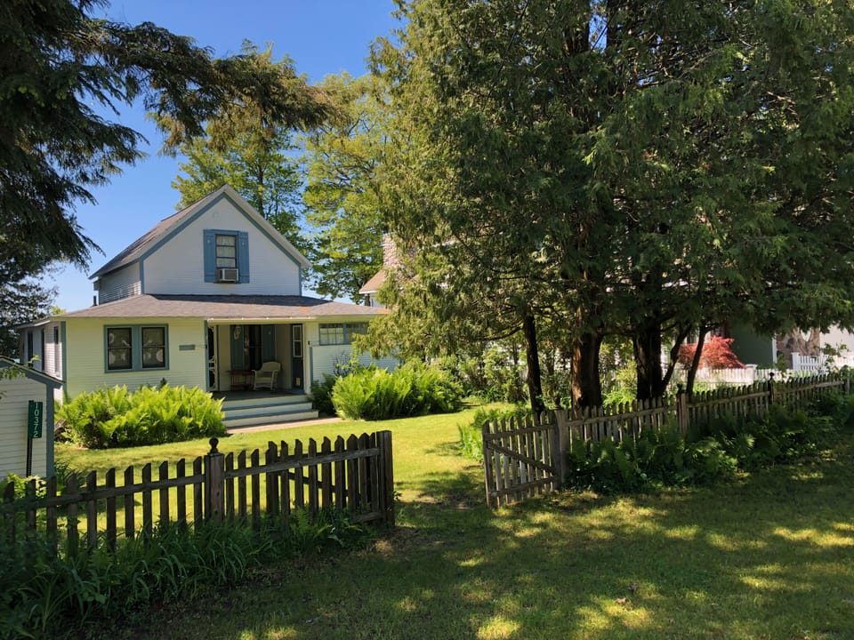 Street-side view of house. Parking along fence or across street.