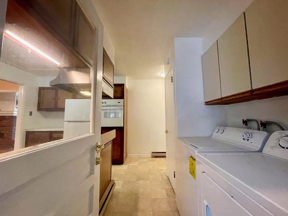 A brand new washer and dryer were just installed in the laundry area.