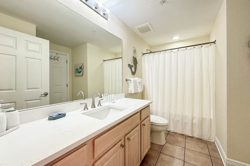Freshly updated bathroom featuring a shower/tub combination, ample vanity space, and modern fixtures.