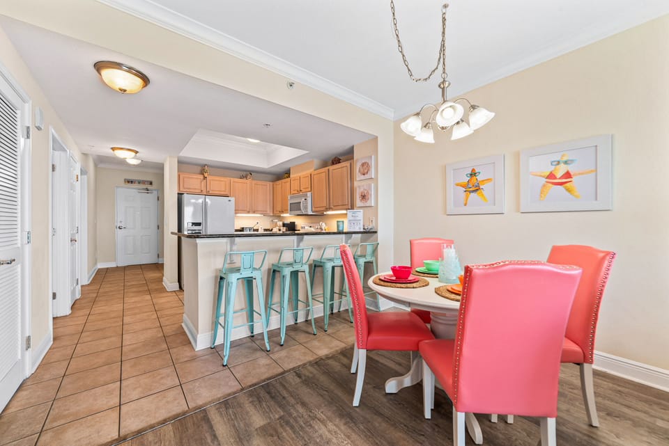 Sleek and sophisticated kitchen featuring a striking island with a stone countertop and comfortable bar stools.