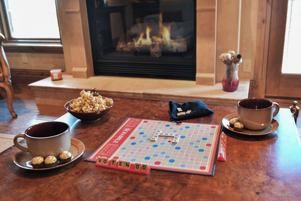 Gather around the coffee table for board games, conversation, and cozy evenings beside the warm glow of the fireplace.