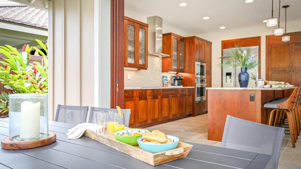 Floor-to-ceiling glass pocket doors allow easy access to the outdoor dining table