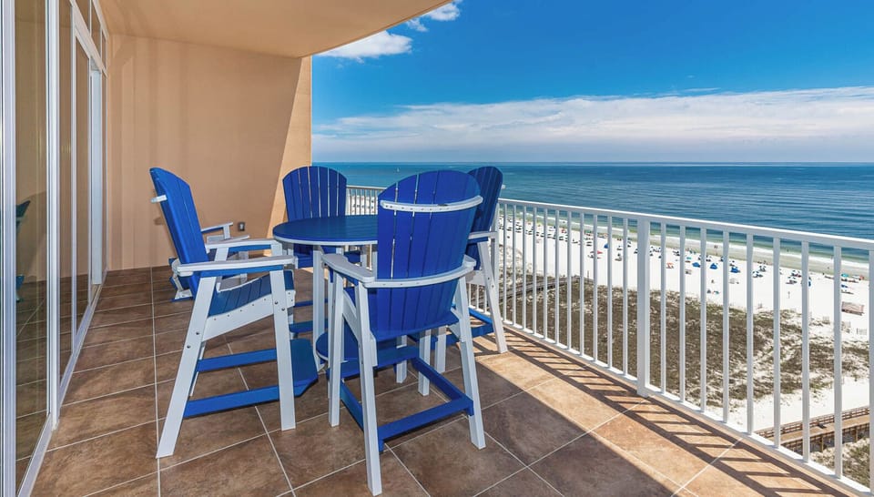 Relax on the balcony's blue chairs, savoring the gentle breeze and stunning views of the coast below