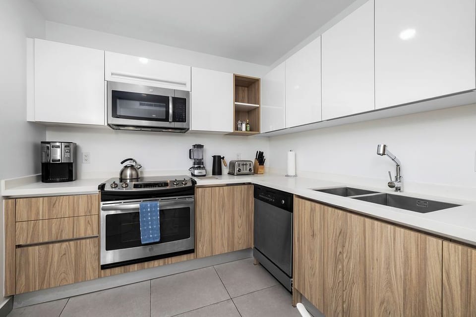 Step into your sleek, modern bathroom with a spacious walk-in shower, dual vanities with premium toiletries, and a bright, open layout that makes getting ready feel effortless.
