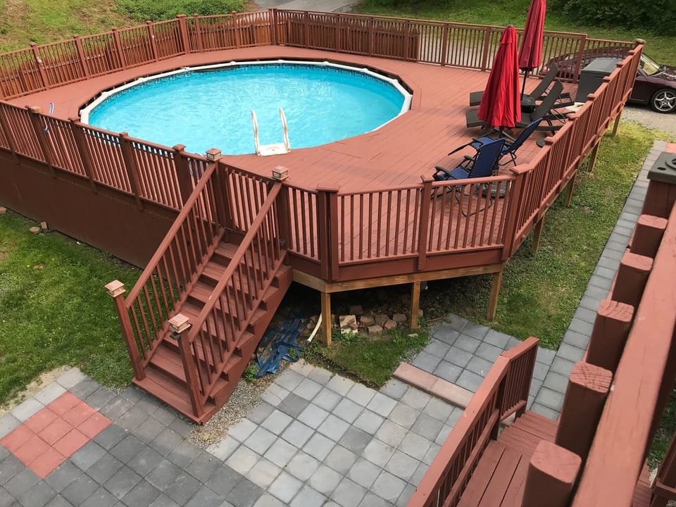 View of summer pool with deck chairs from #517 loft bedroom private balcony 