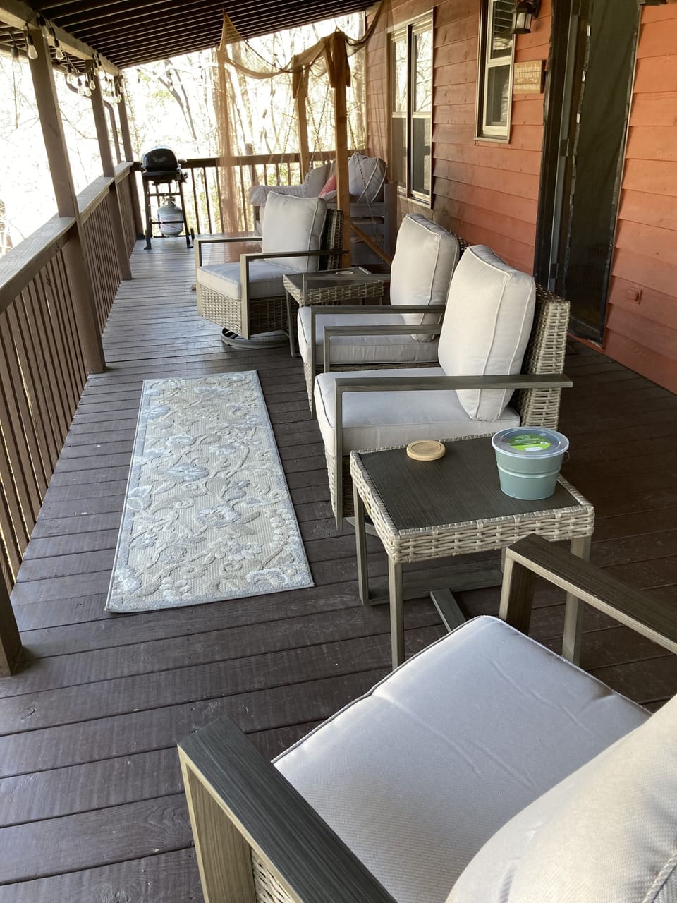 Main level back deck has seating to enjoy the view. 