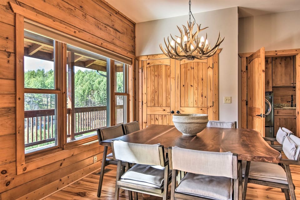 Set the dining table for a family-style meal beneath the antler chandelier.