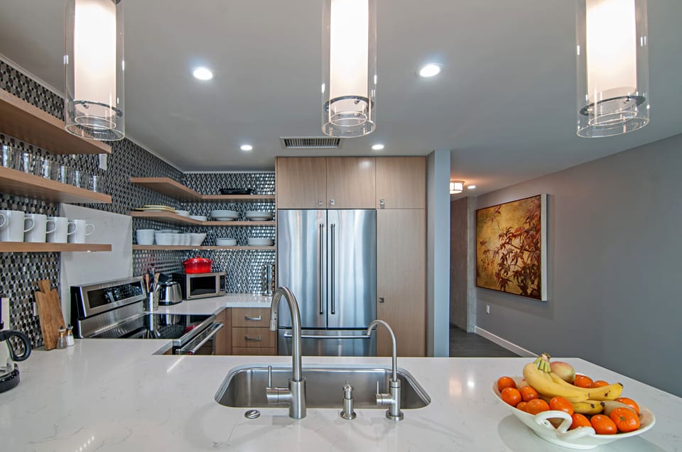 Kitchen is completely custom with induction range and waterfall quartz counter