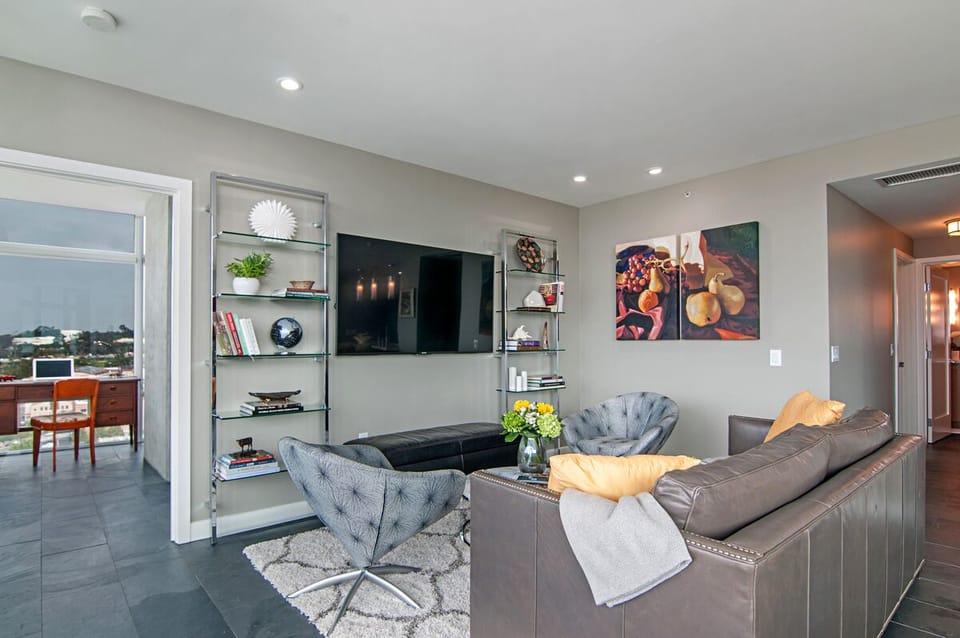 Living area with 65" smart TV and Sonos sound bar