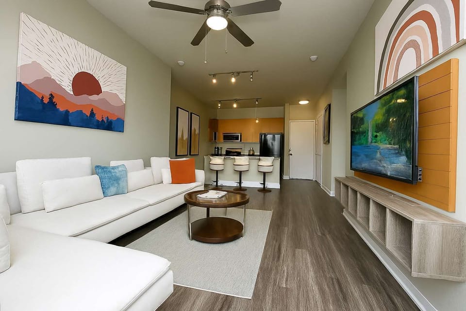 Cozy room with ceiling fan, wall decor, and bright window