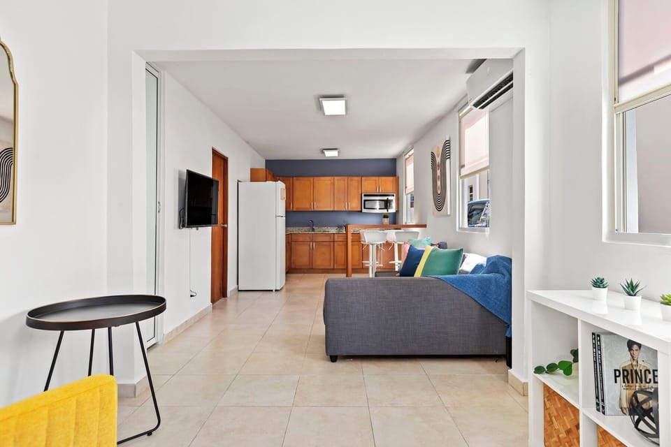 A chic and comfortable space. Our living room is designed for both style and function, with a TV for entertainment and a large mirror to open up the room.