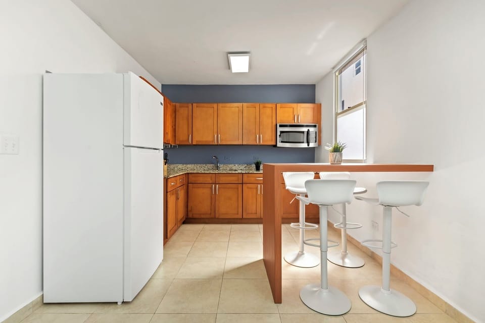 Cook with confidence! Our well-equipped kitchen features beautiful wooden cabinets and modern appliances, ready for all your culinary needs.