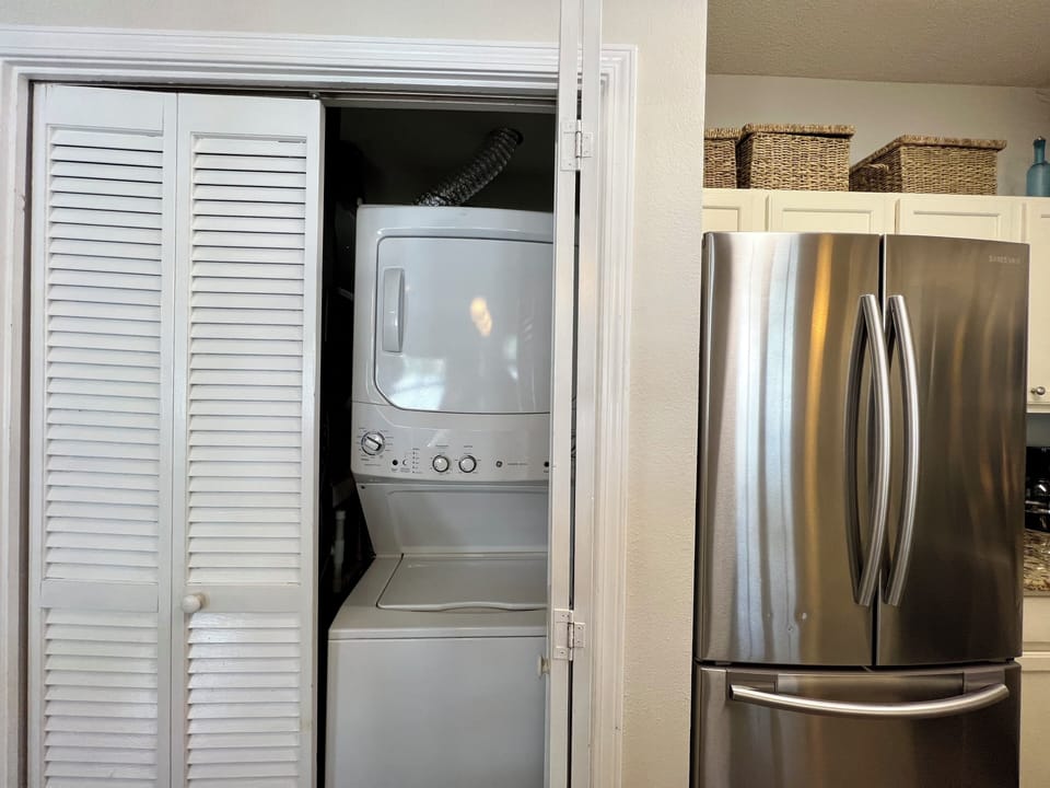 Keep your clothes fresh with convenient in-unit laundry facilities, complete with stackable washer and dryer tucked behind elegant louvered doors.