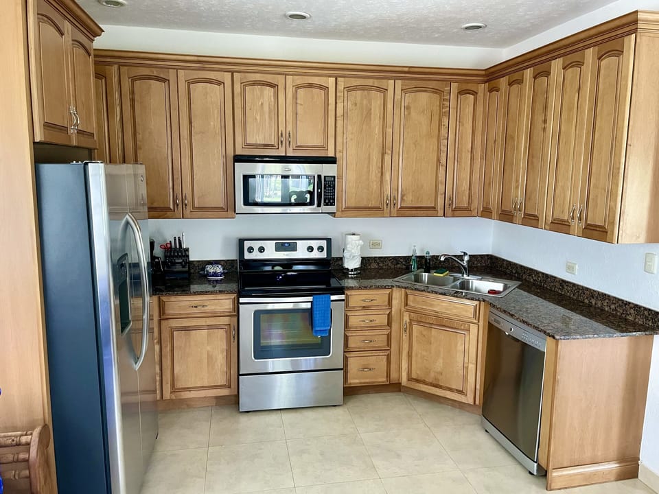 Fully equipped kitchen with GE stainless steel appliances, dishwasher & blender