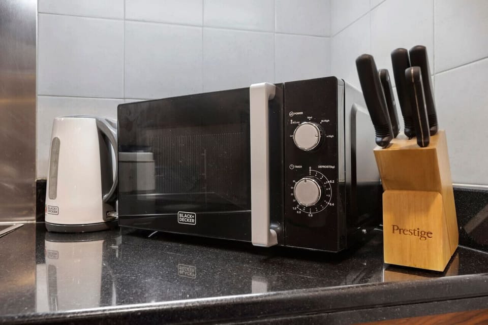 Modern Kitchen: Whip up culinary delights with top-notch appliances and sleek countertops!