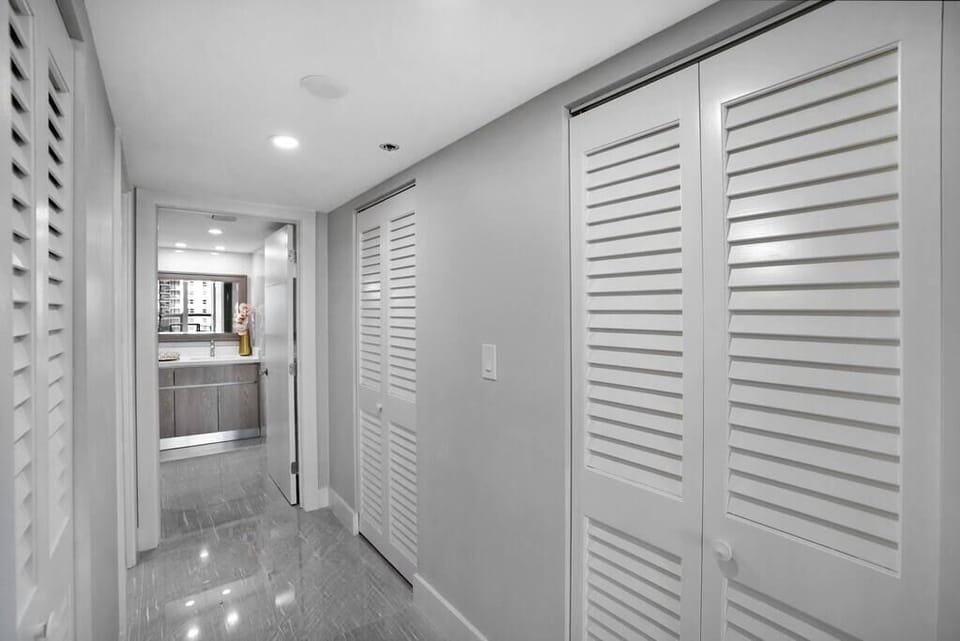 Master bedroom walk in closet with view of private bathroom