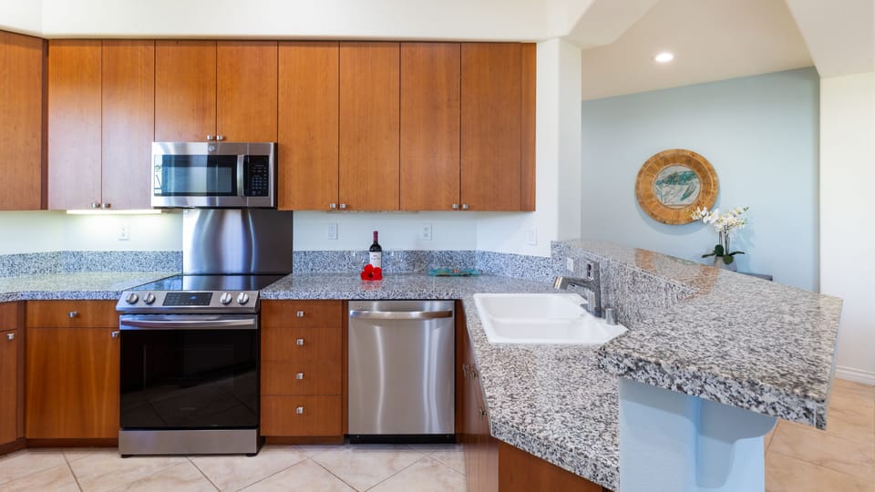 Gourmet kitchen stocked with spices, oils and cookware essentials.