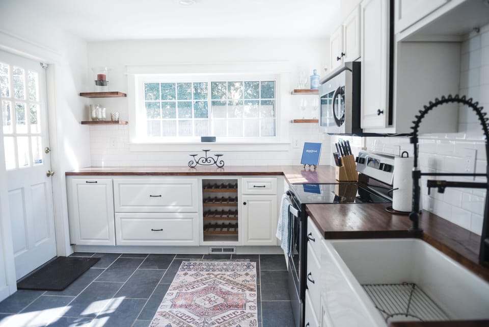 Updated kitchen with oven, microwave, farm sink, refrigerator, + all the things 