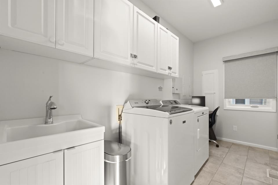 Laundry room with washer and dryer plus all the laundry pods you'll need for your stay.  A dedicated work space is also tucked away in the laundry room.