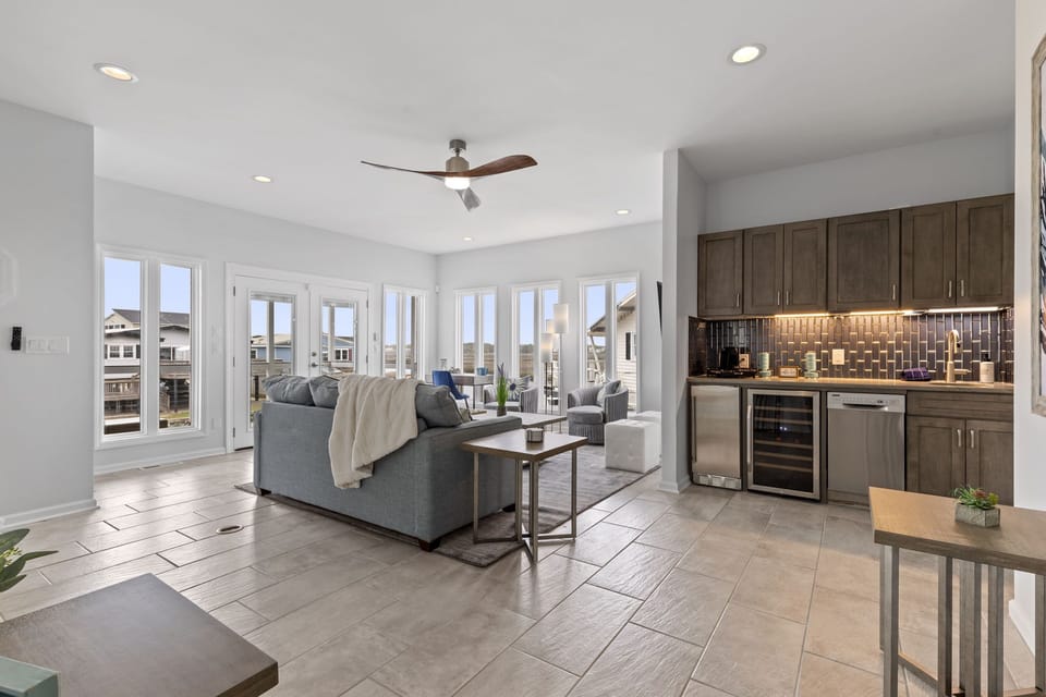 Second floor living room with amazing views of the salt marsh, queen sleep couch and adult wine/coffee/espresso bar.  Two (2) bedrooms on this level.