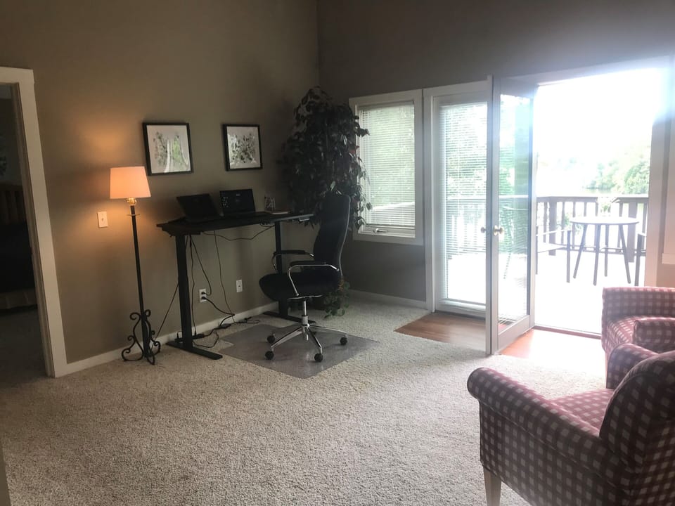 Upstairs loft area with deck and view of lake