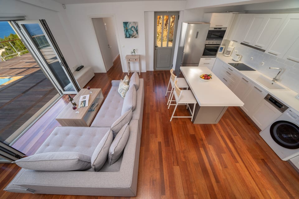 Kitchen with washer, dryer, dishwasher, oven, microwave and refrigerator. 