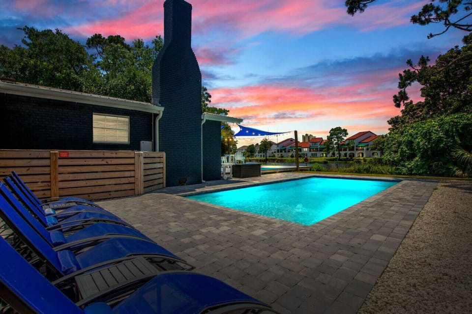 Step into Poseidon`s Palace, where twilight casts a magical glow over our pool area, offering a breathtaking view of the lagoon.