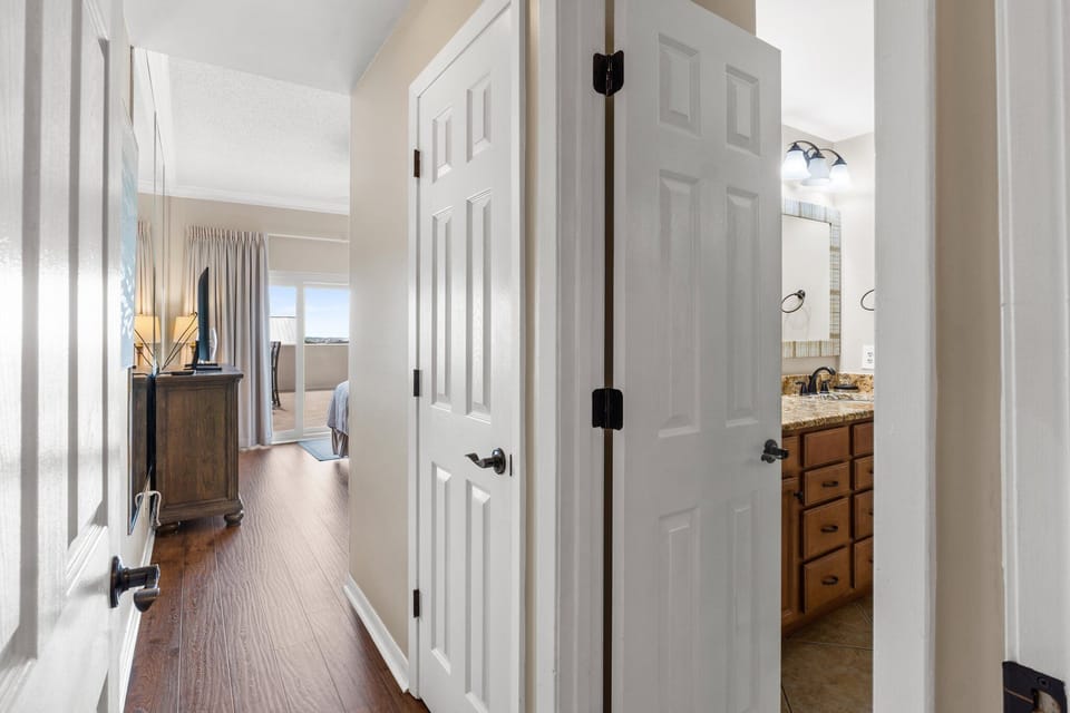 Main bedroom has large flat screen TV, cable, free WiFi, dresser, & private balcony with Gulf views.