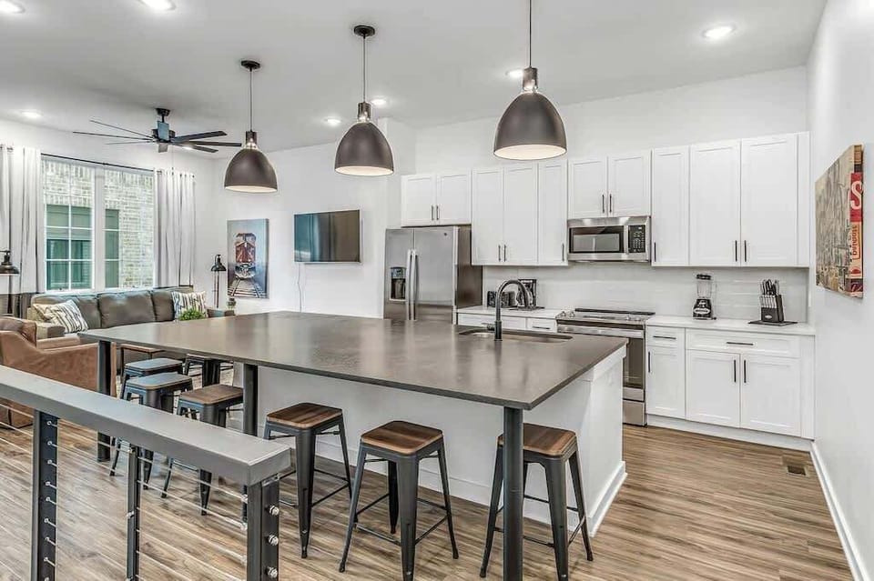 Open-concept floor with large kitchen island for cooking and dining.