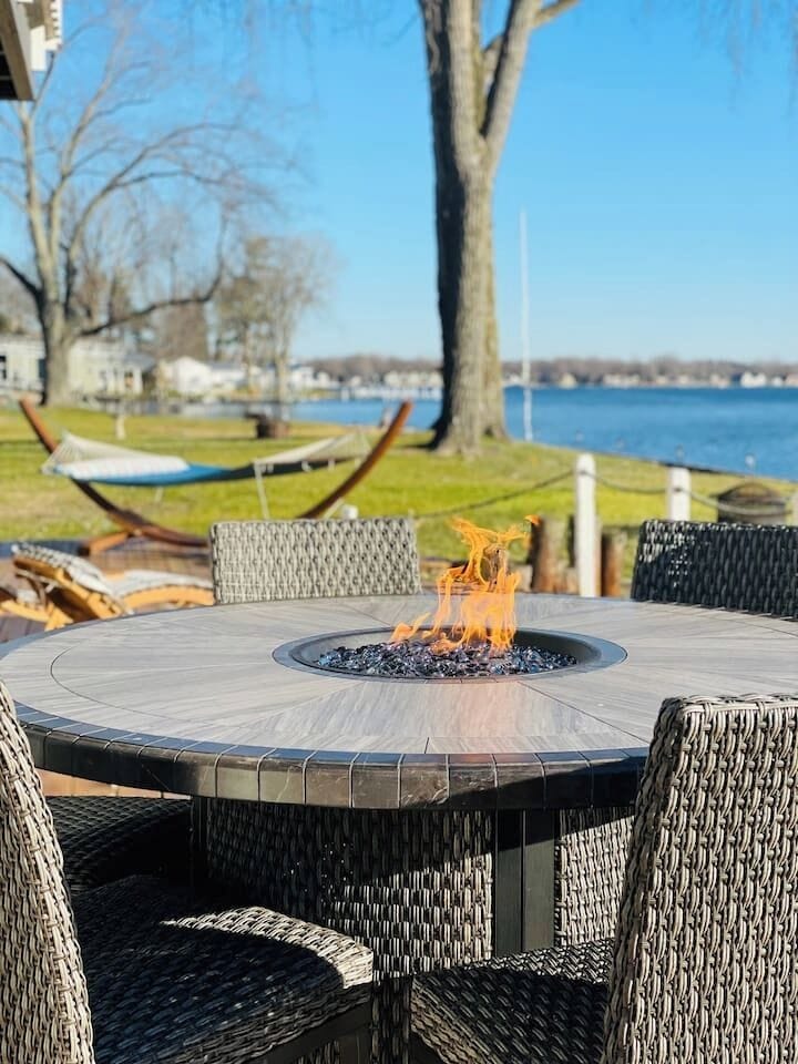 Outdoor fire pit table perfect for relaxing evening by the lake.