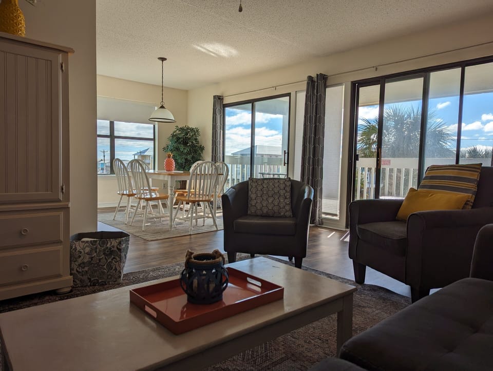 Living room has a view out the two sliding doors to the covered porch. 