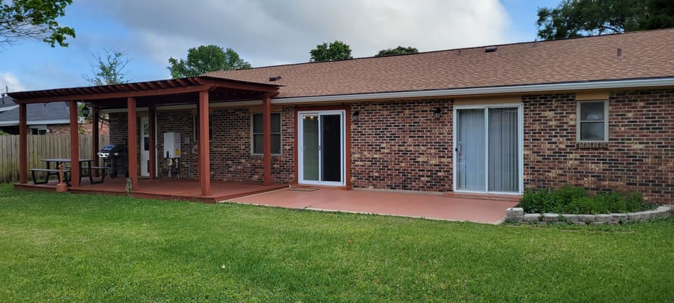 The backyard features a nice lawn & garden. It has a covered deck and gas grill.