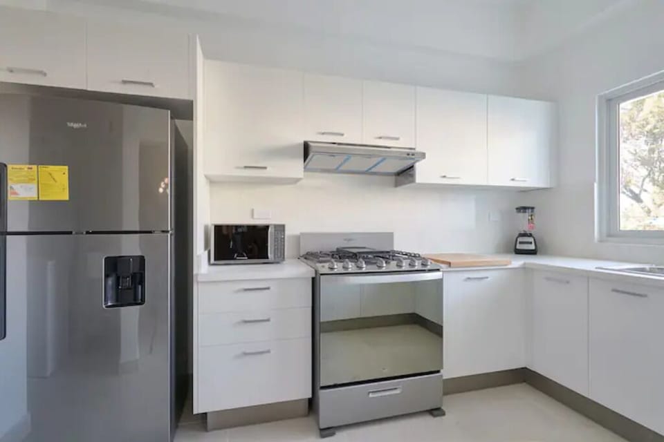The Spacious Fully Equipped Kitchen is filled with all the utensils you need.