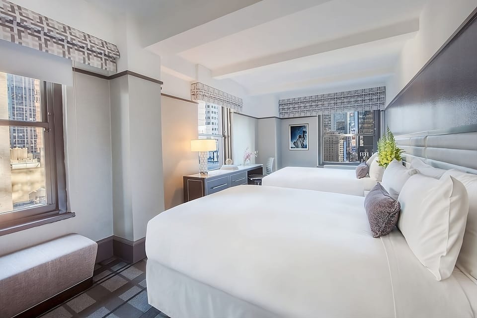 Wake up refreshed in crisp beds with bright city views.