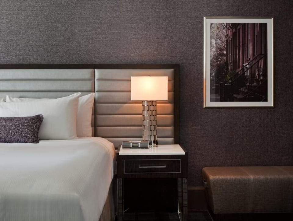 Settle in with warm bedside lighting and curated artwork.