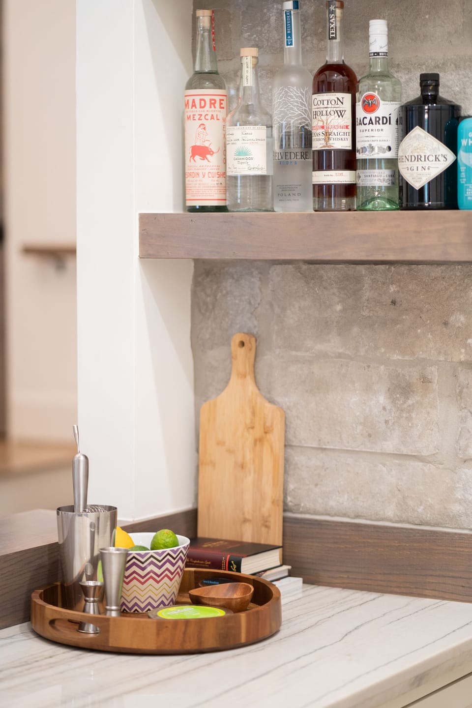 Bar area off kitchen includes sink, bev/wine fridge, shelving