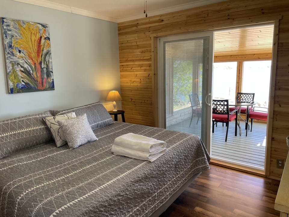 Master bedroom with king size bed and access to screen porch