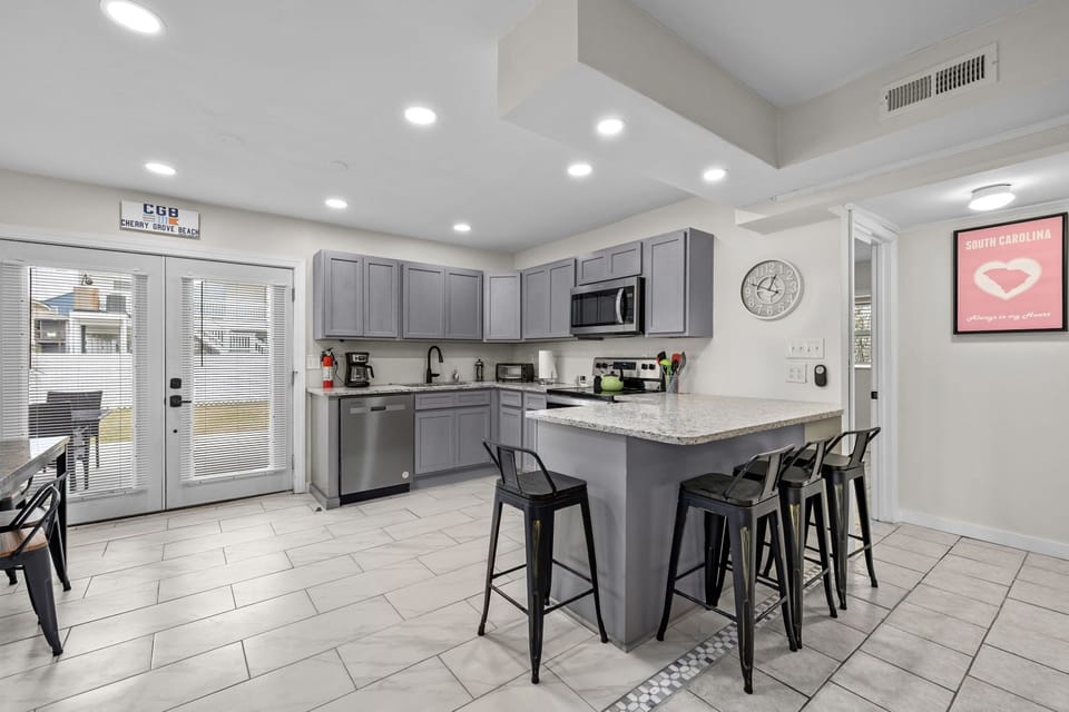 Kitchen looking to yard and rear bedroom