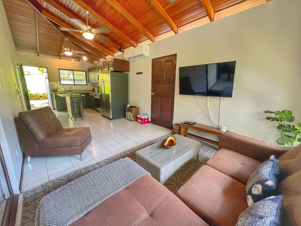The comfortable living space has a 48" Smart TV and is connected to the screened in balcony area.  You can also access the yard via an outdoor staircase.