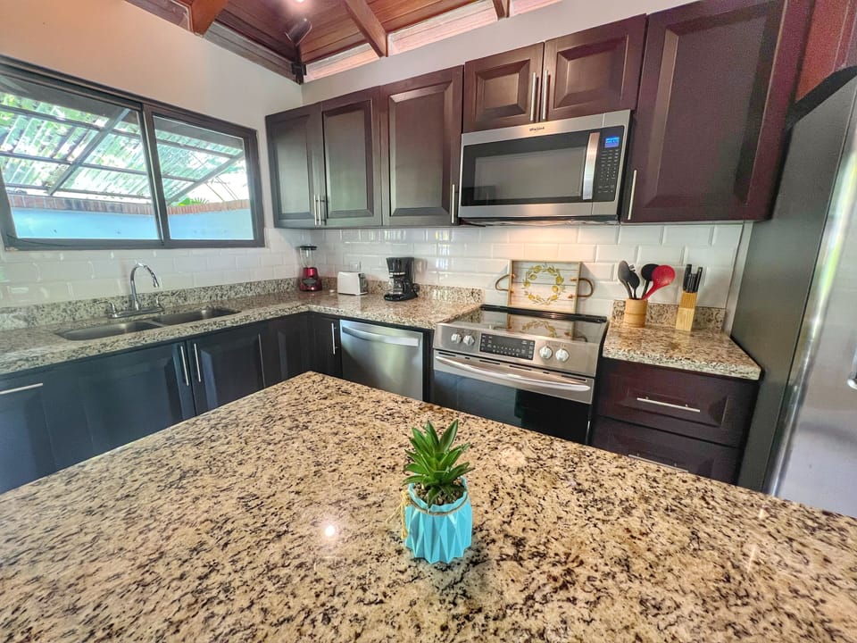 The kitchen has full-size, stainless steel appliances including a 5-burner stove and dishwasher.