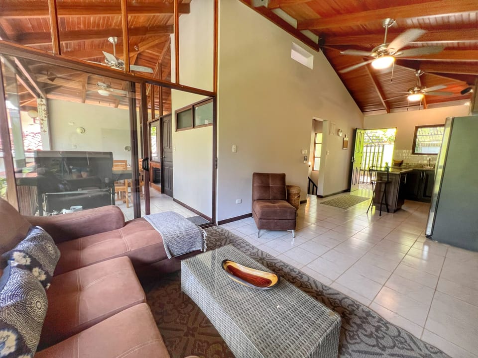 The comfortable living space has a 48" Smart TV and is connected to the screened in balcony area.  You can also access the yard via an outdoor staircase.